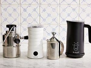 Assortment of the best milk frothers that we recommend on a marble surface