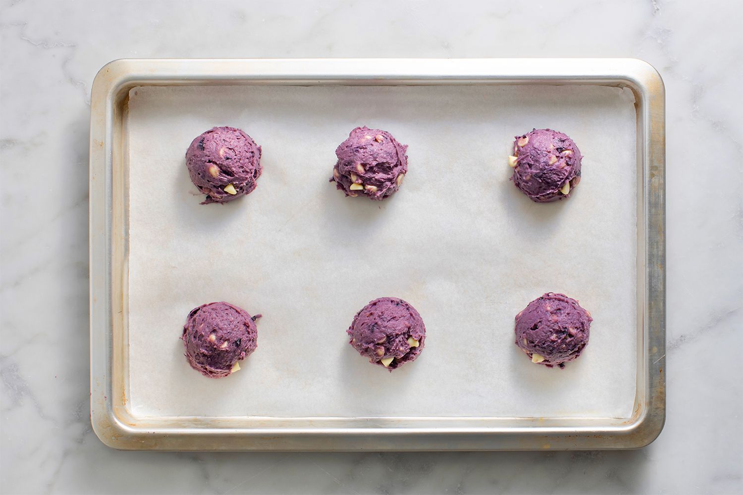 Cookie dough balls on a baking sheet 