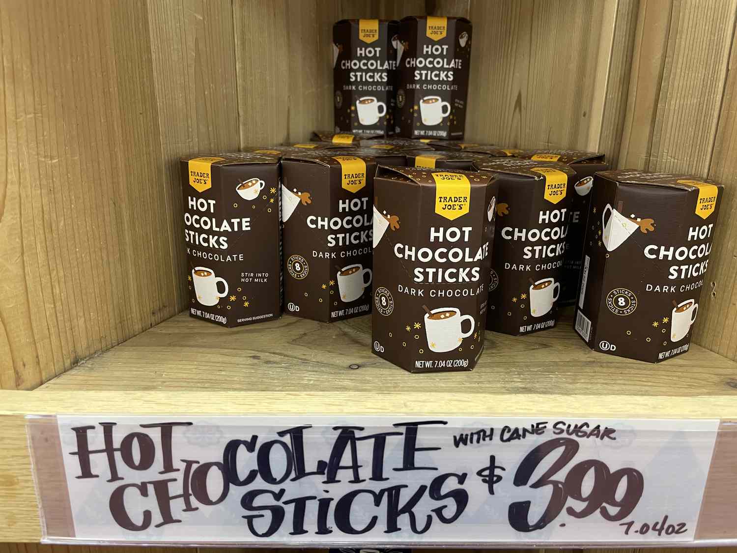 Hot chocolate sticks on a shelf with a price of $3.99