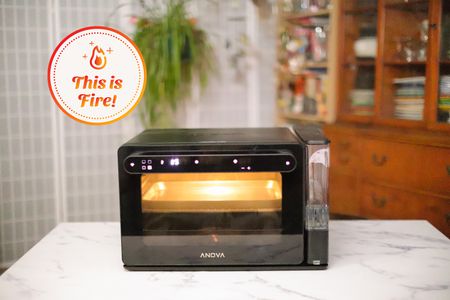 Anova Precision Oven displayed on marble countertop with nearby wood hutch