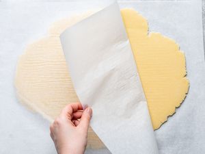 Peeling back parchment paper from the craquelin