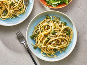 Two bowls of dirty martini pasta, served with a side salad