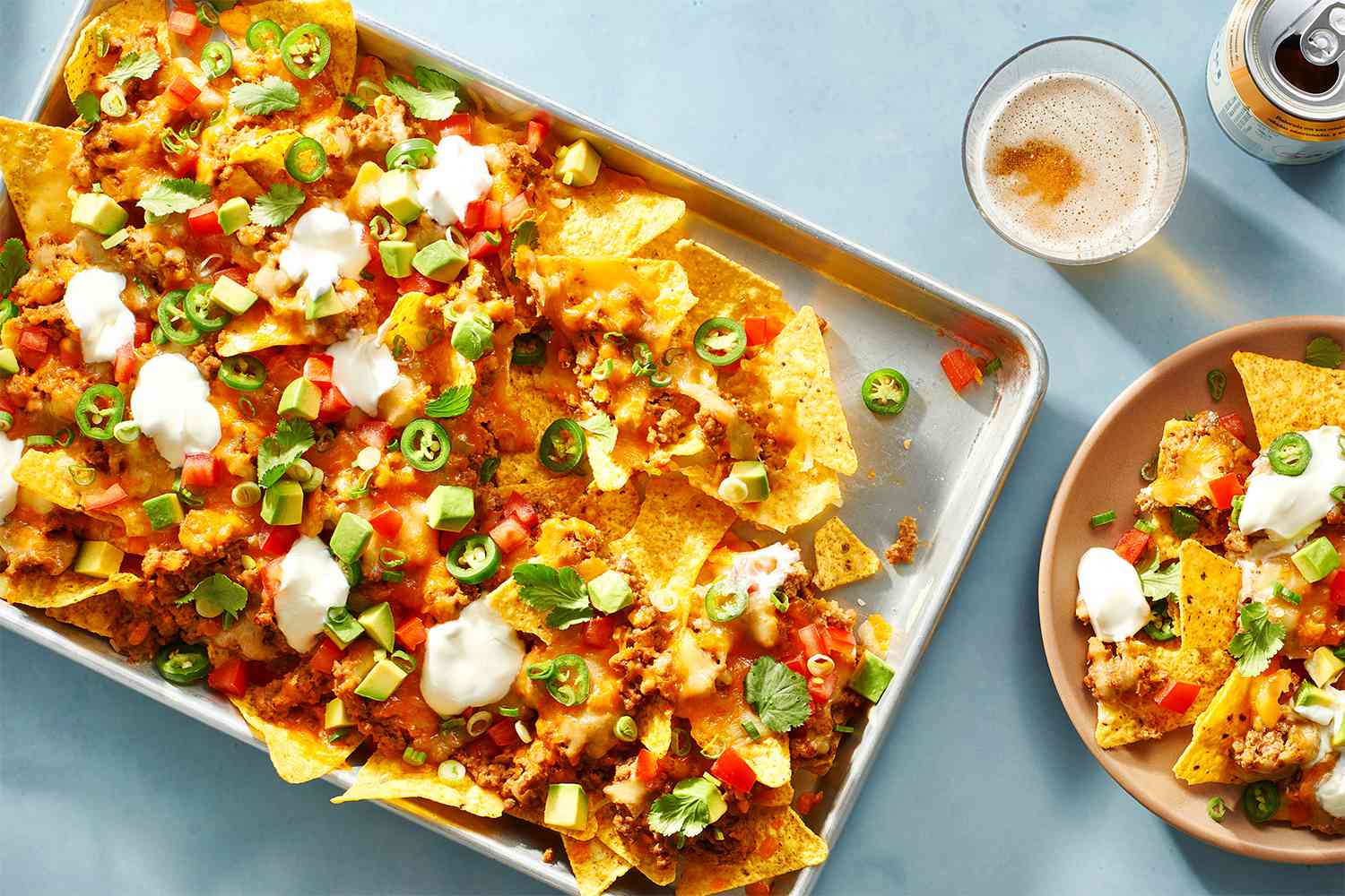 Easy Loaded Nachos on a baking pan and on a plate 