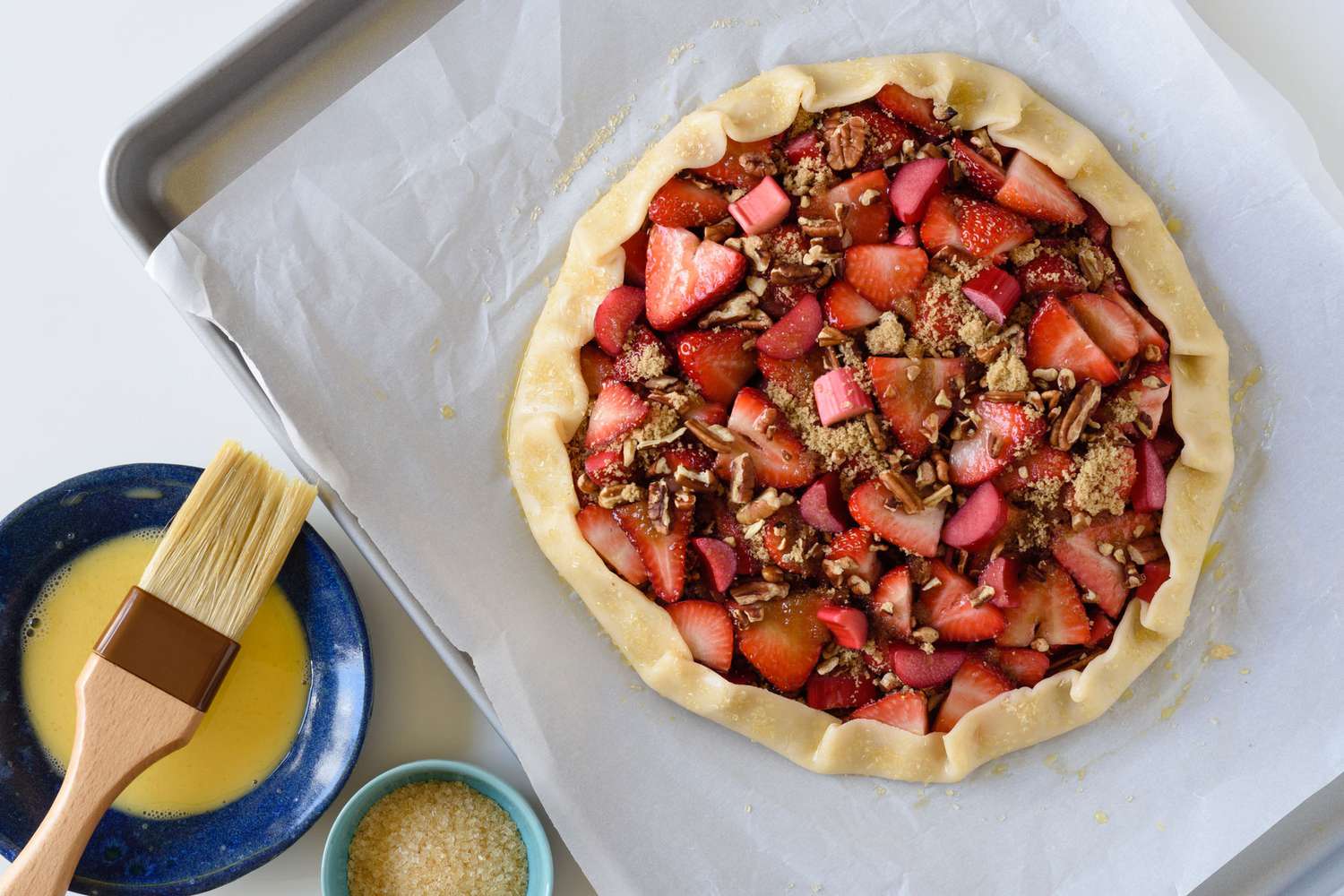 Rhubarb and strawberry galette with pastry brush and butter