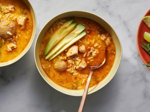 asopao de pollo in bowls topped with avocado slices