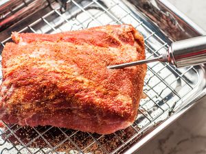 Pork injection marinade being injected into a seasoned piece of pork