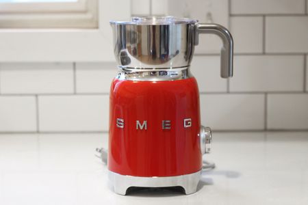 SMEG 50's Retro Milk Frother displayed on a white counter