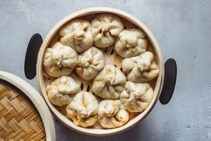 Steamed Chinese BBQ Pork Buns (Char Siu Bao) in a steamer basket 