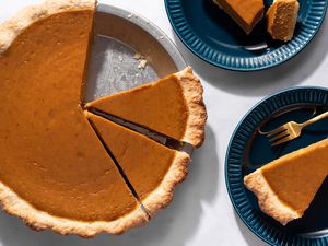 Dairy-Free Pumpkin Pie in a pie plate and on plates 