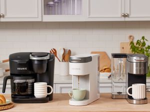 Three Keurigs displayed on a kitchen counter