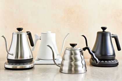 Four gooseneck kettles displayed on an orange background