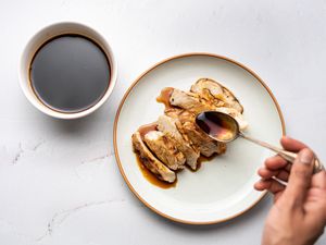 Teriyaki sauce being poured over chicken