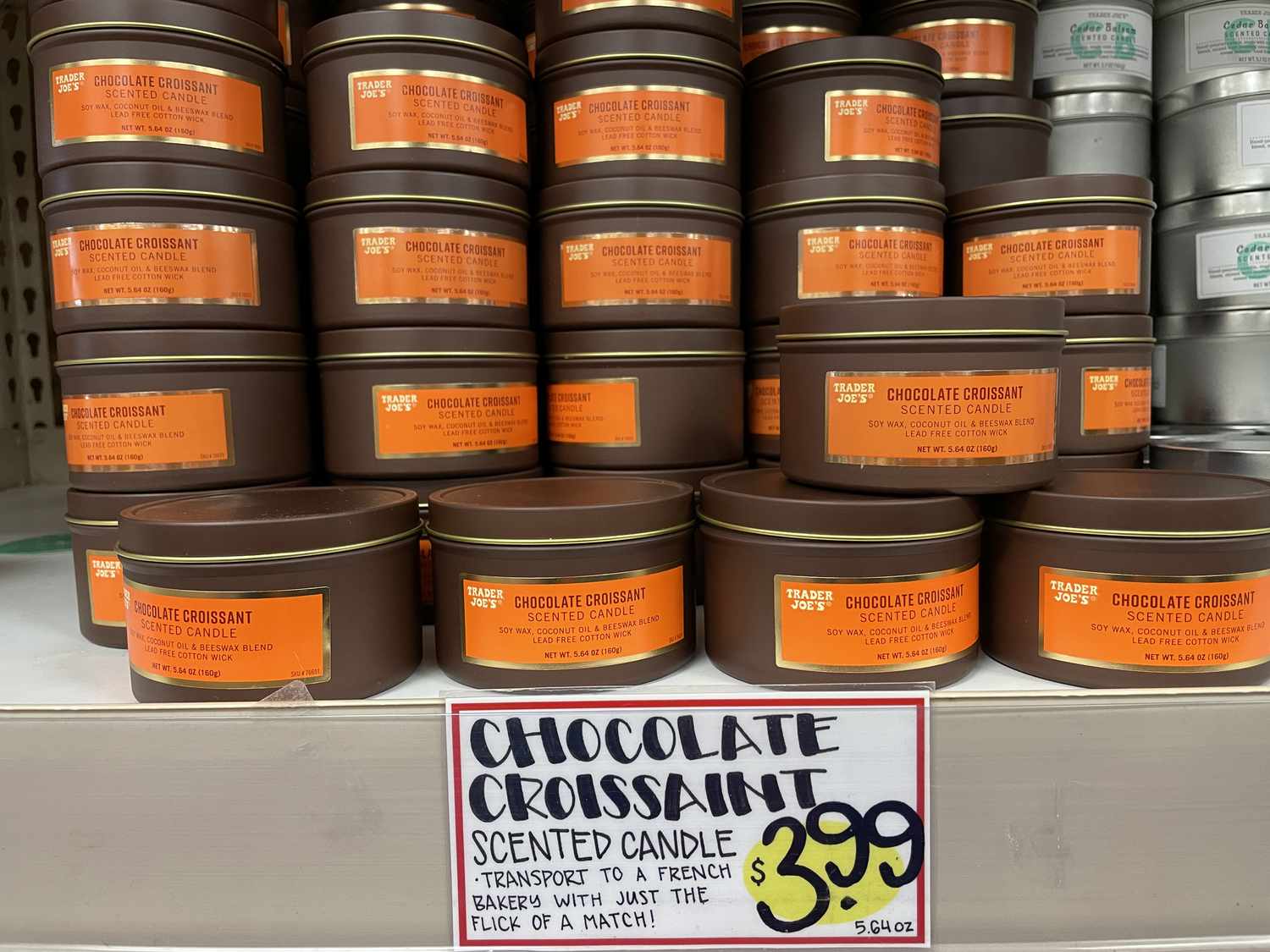 Chocolate croissant scented candles on a shelf with a $3.99 price tag