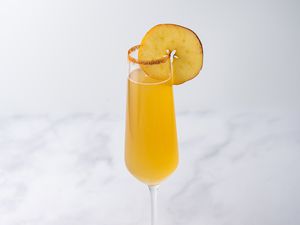 Apple Cider Mimosa in a Champagne glass 