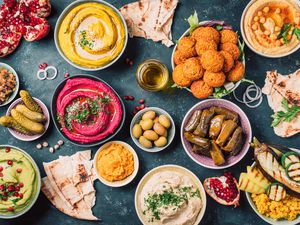 Mezze spread with pita bread, dolmas, hummus, baba ghanoush, and more