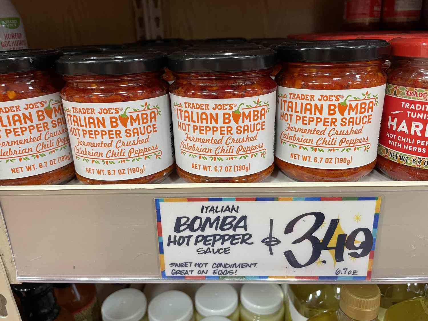 Trader Joe's Italian bomba hot pepper sauce on a shelf with a $3.49 price tag