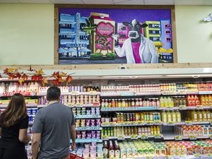 people shopping at Trader Joe's refrigerated aisle