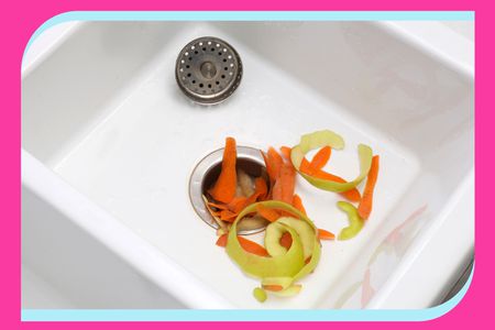 A kitchen sink with food scraps