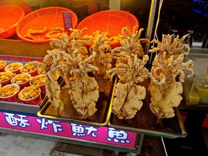 Deep fried calamari on skewers on market stall