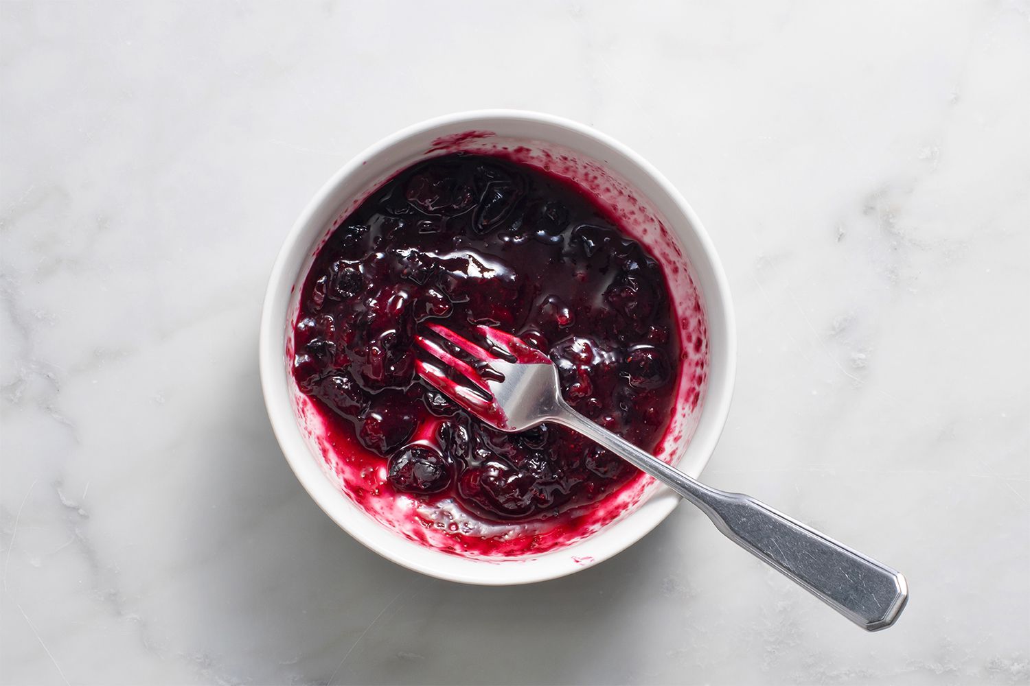 Blueberries in a bowl with a fork 