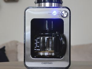 Chefman Grind and Brew Coffee Maker displayed on wood table