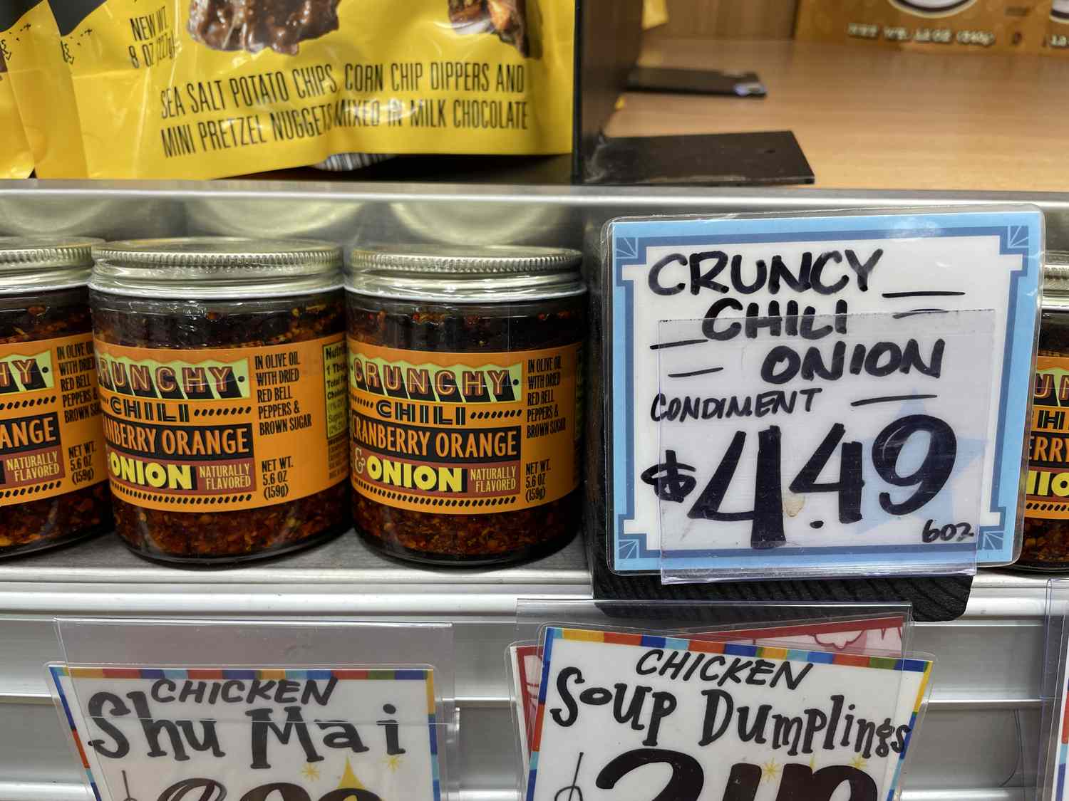 Crunchy chili cranberry orange and onion condiment on a shelf with a price tag that says $4.49