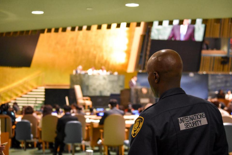 UN security officer overseeing the UN General Assembly hall.