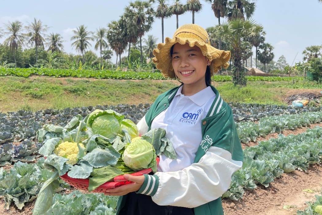 young woman in a field with cabbages