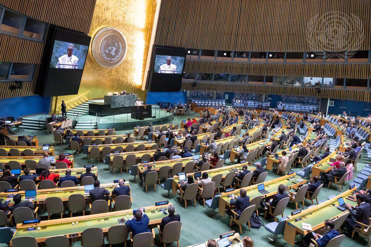 panoramic view of the General Assembly Hall, with the President of the 79th session at the podium and on the monitors