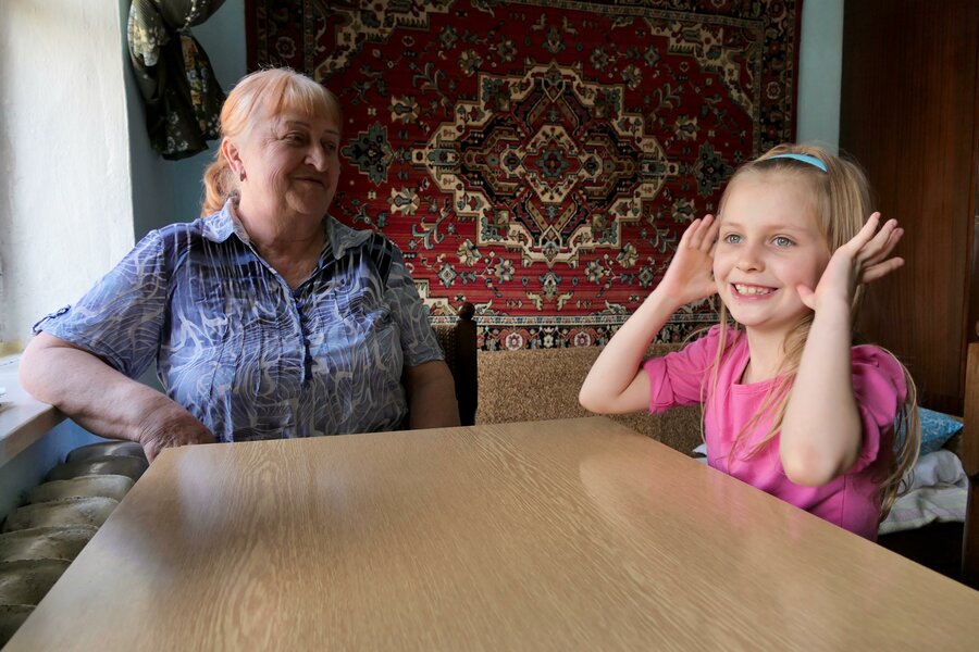 woman and little girl sitting at table