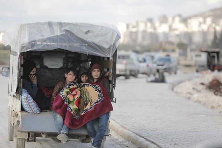 family in the back of a truck