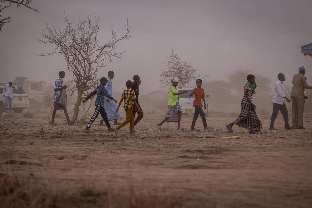 people walking in dusty environment