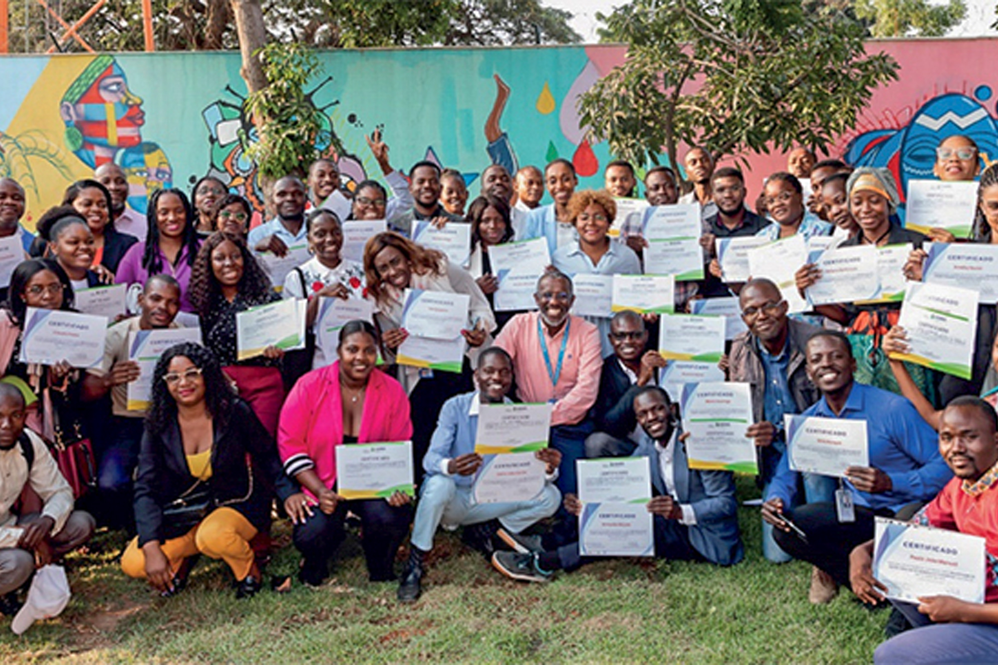 A group of people outdoors showing a certificate