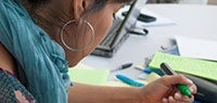 Woman taking notes with green highlighter