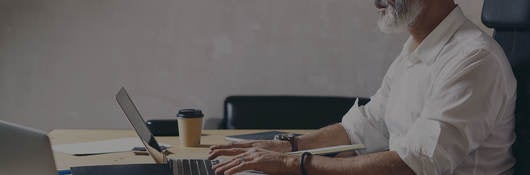 Man sitting in front of computer at a desk