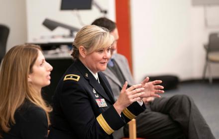 Woman in uniform sitting and talking