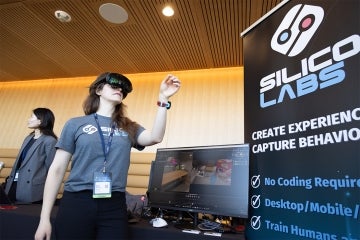 a woman demonstrates a VR experience for Silicon Labs at the University of Toronto