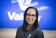 Proud employee in front of Valero marquee