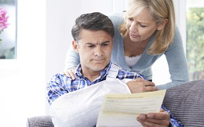 Injured man and woman looking at paperwork