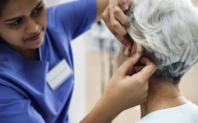 Woman getting fitted for a hearing aid