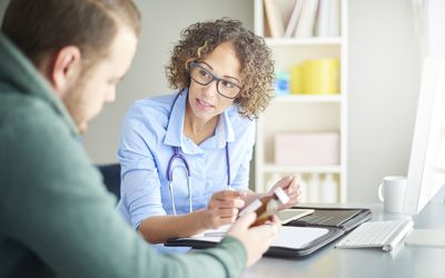 Doctor giving patient prescription drugs