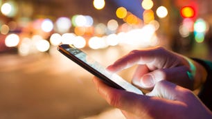 Man using his Mobile Phone in the street, bokeh