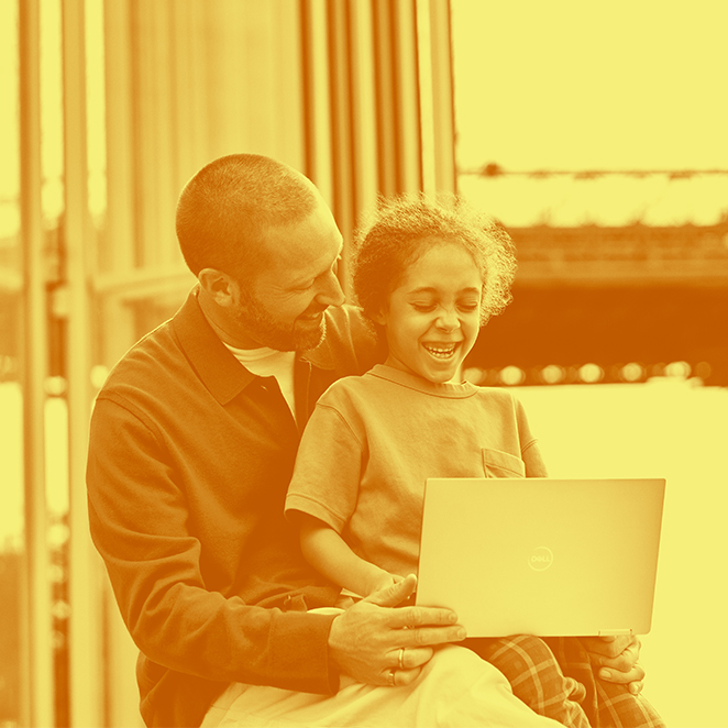 A parent and child look at a laptop