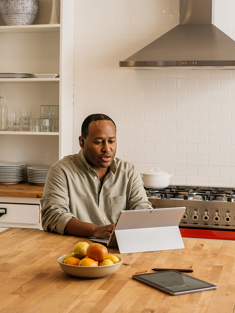 Photos show a man working in multiple environments—company headquarters, at home, at a satellite office, and in a coffee shop.