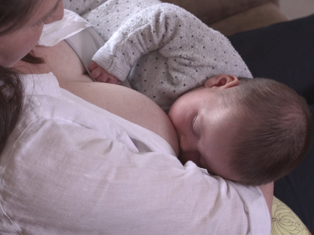 baby breastfeeding with mom