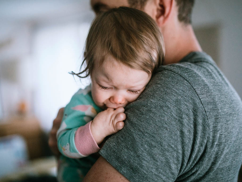 Dad holding baby who is congested