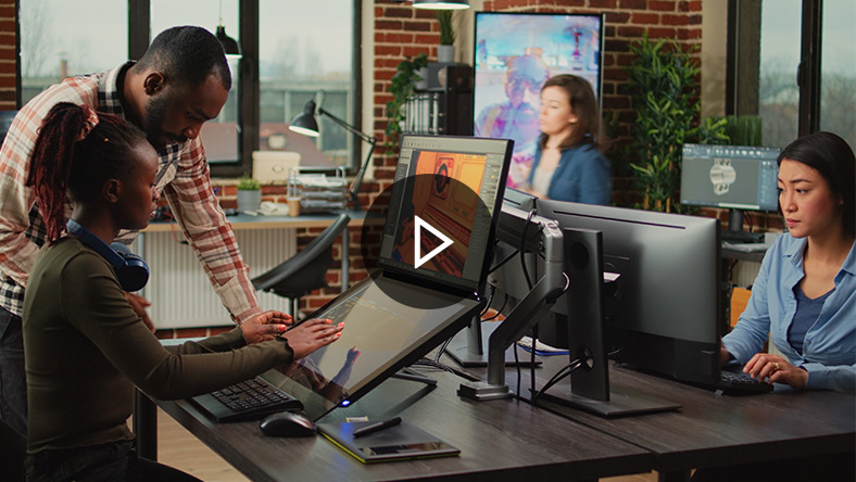 A team of four working on computers in an office.