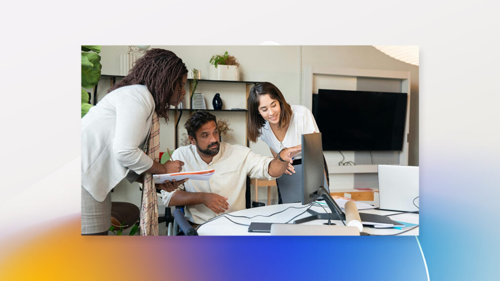 man using computer with orange and blue