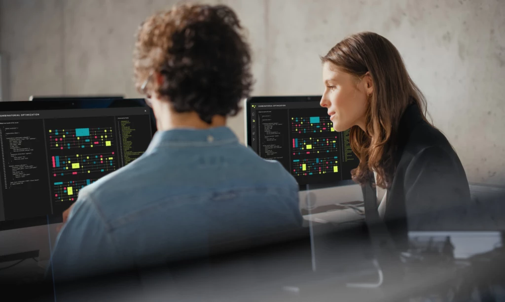 Two people working together looking at computer screen