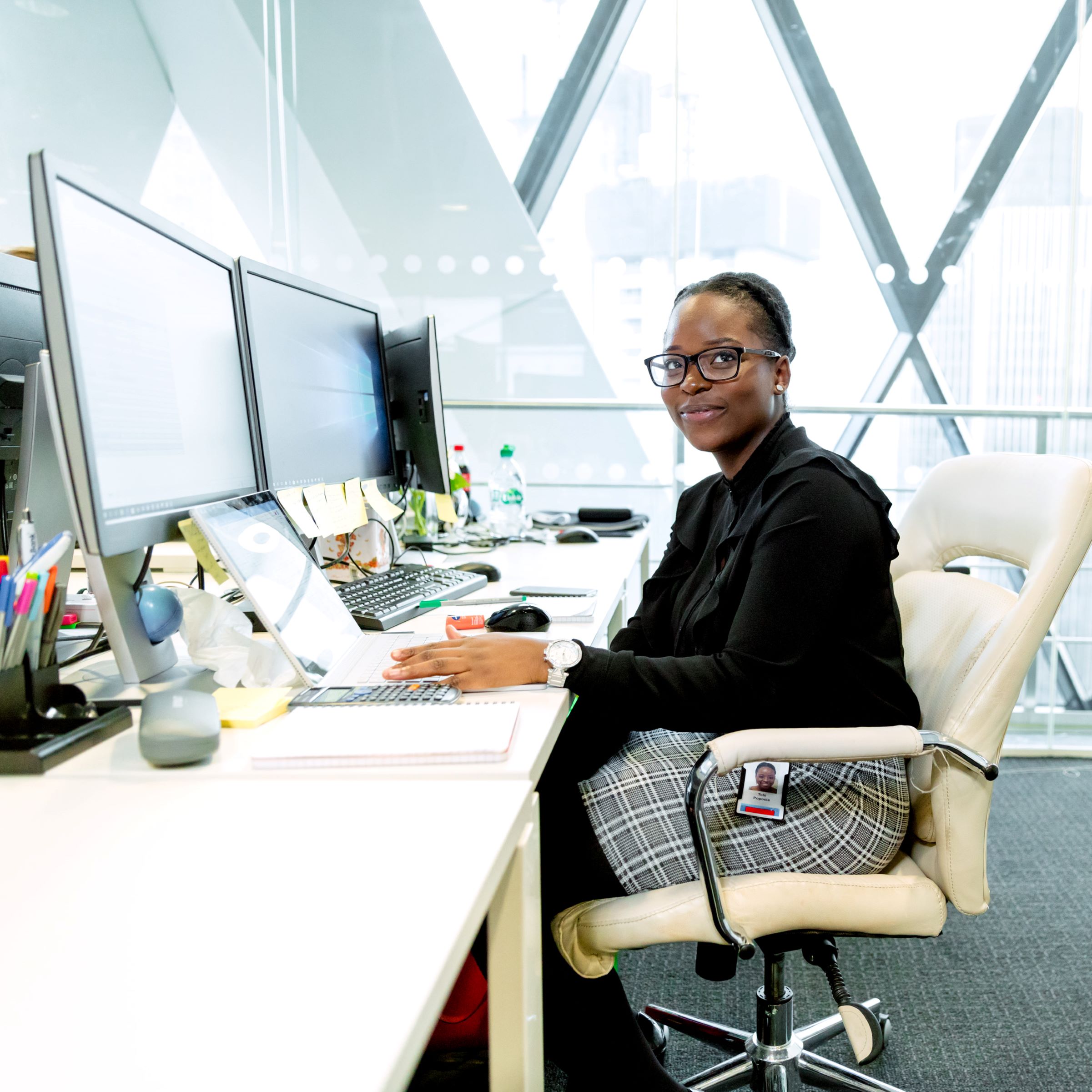 a person sitting at a table in front of a laptop